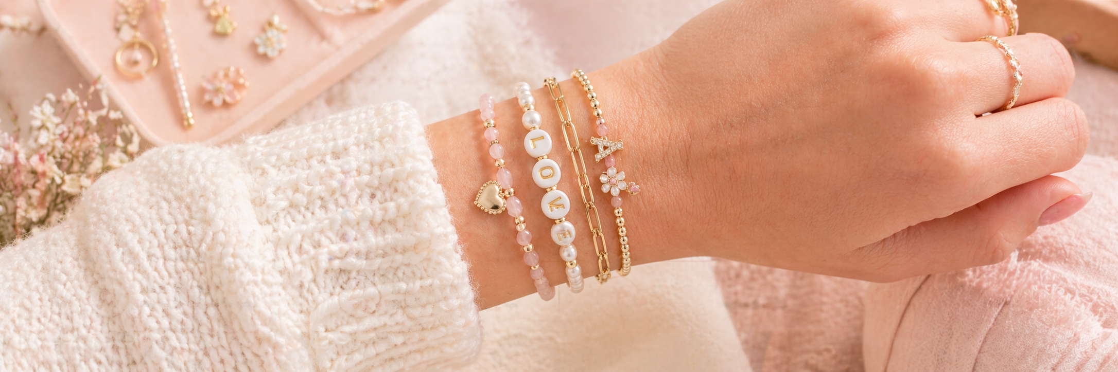 Banner image of jewelry charms laid out on a tray